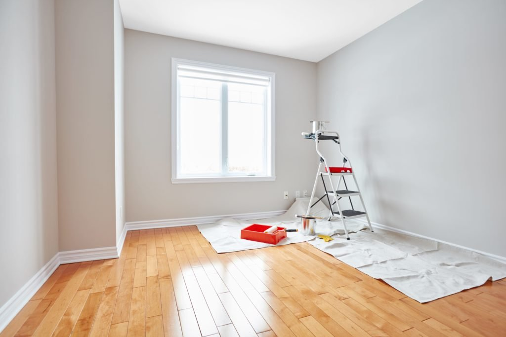 A room with some paint and ladder in it