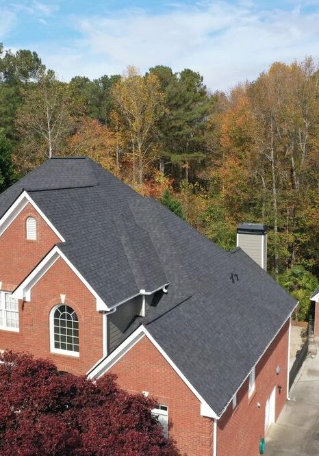 A red brick house with two garage doors.